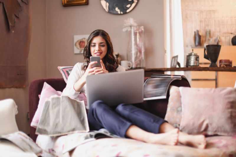 woman using smartphone while lying on couch 3768602